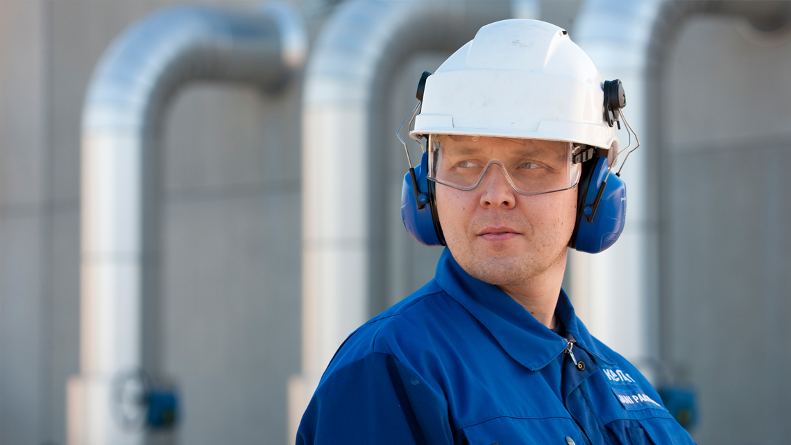 Factory worker with the helmet and earmuffs.