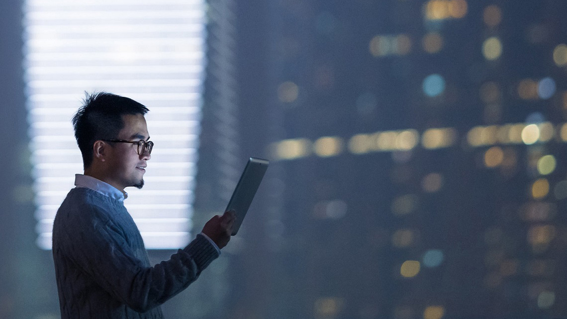 A person looking at the tablet computer.