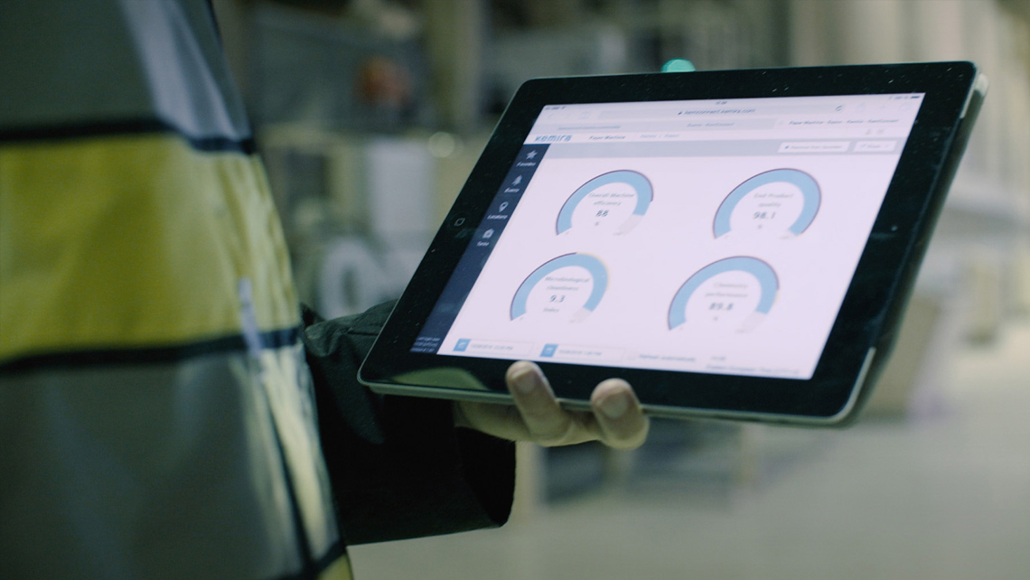 A factory worker holding a tablet.