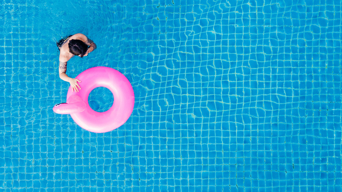 Top view of a person on a swimming pool.