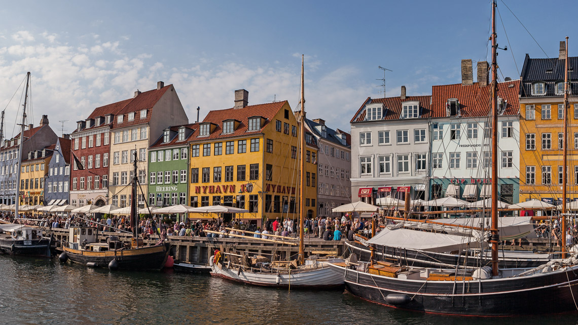 Copenhagen city view with canal and colorful buildings.