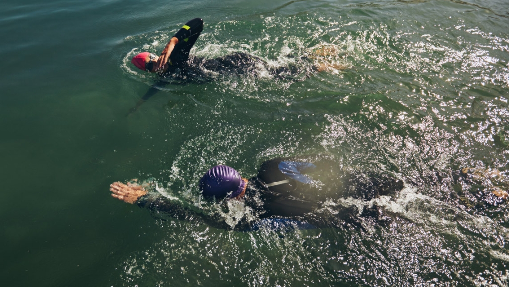 Athletes practicing swimming for triathlon race.