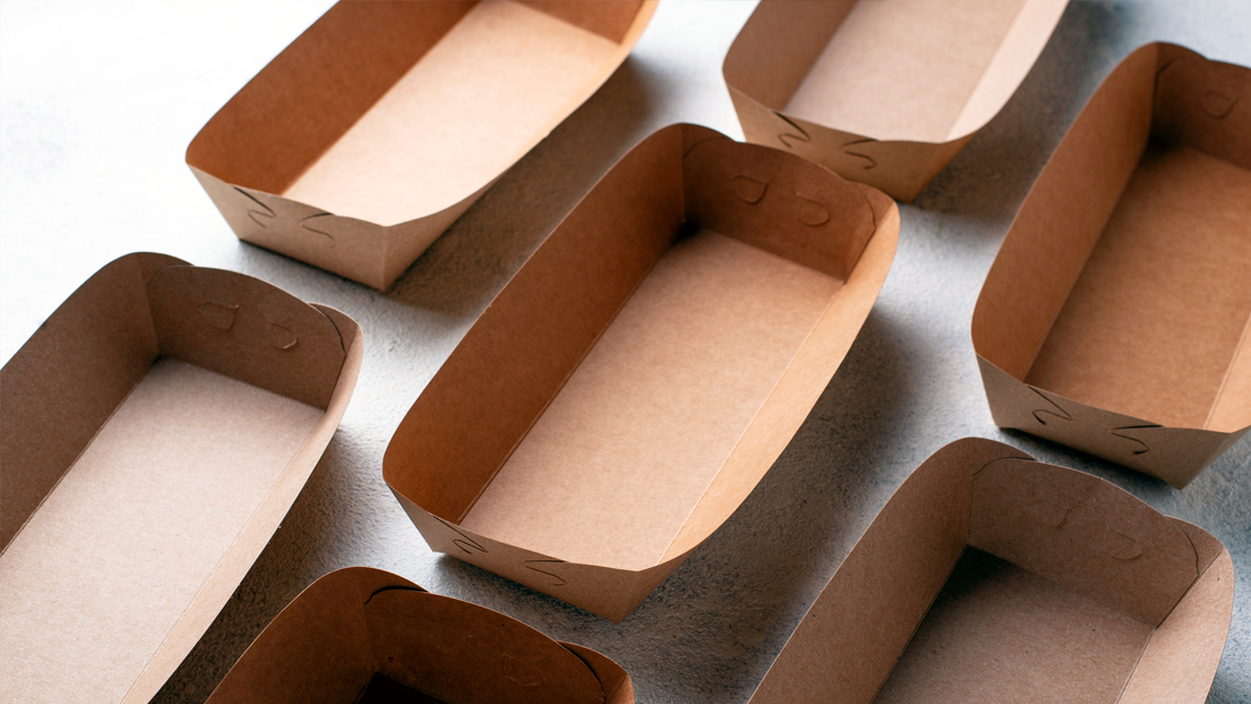 Several brown food packages on the table.