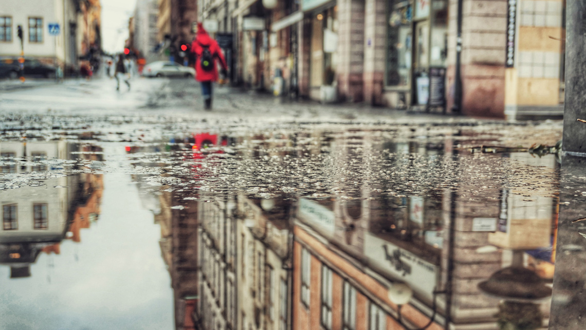 Puddle reflection in Stockholm city street.