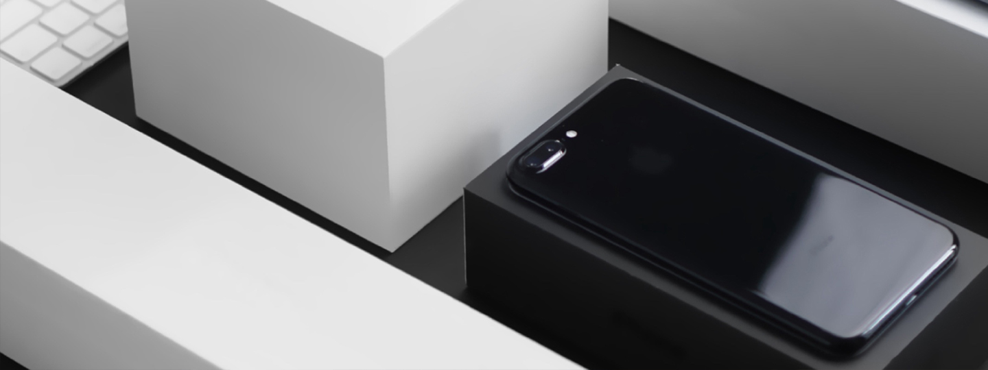 Black smartphone on a white cardboard box.
