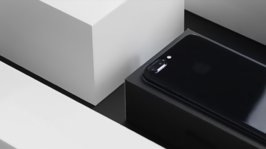 Black smartphone on a cardboard box.