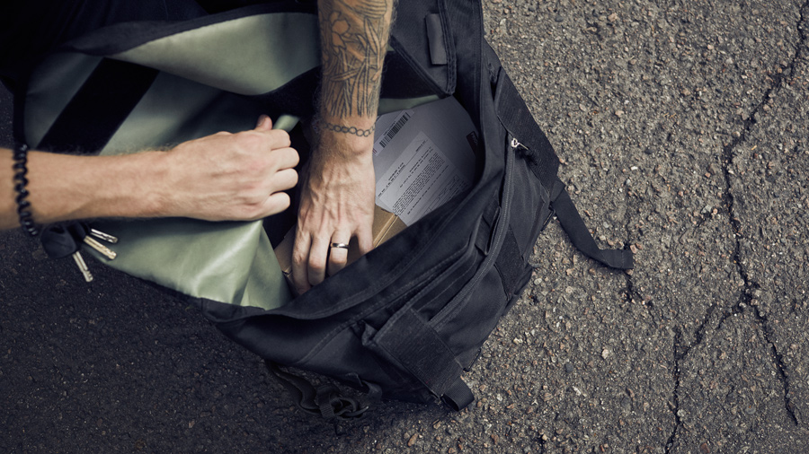 A person reaching a package from a bag.