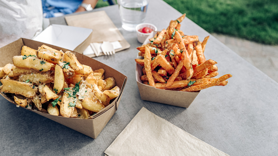 Fries in a brown food packages.