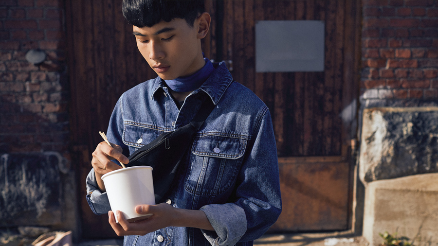 A person eating takeaway food outside.