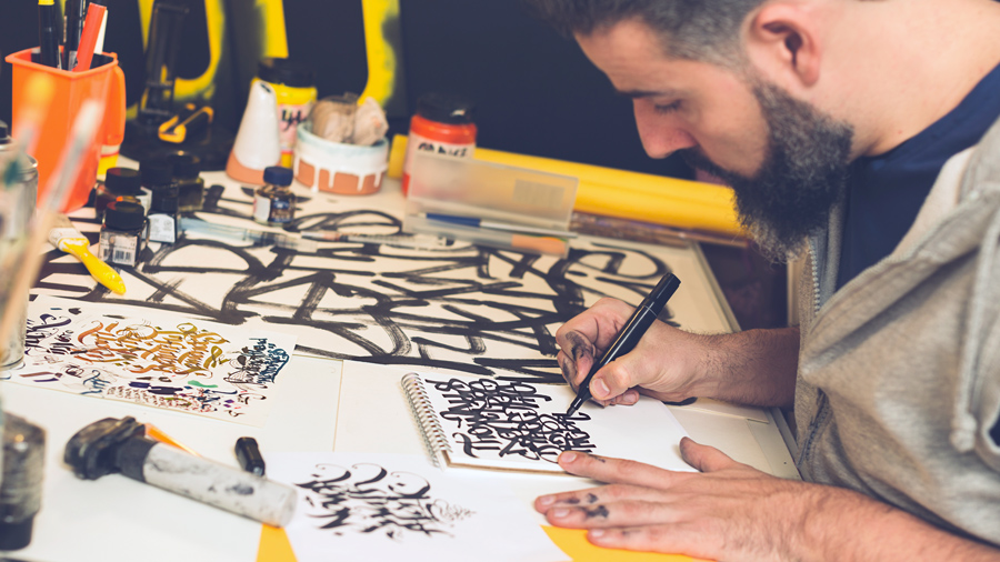 A person making calligraphy artwork.