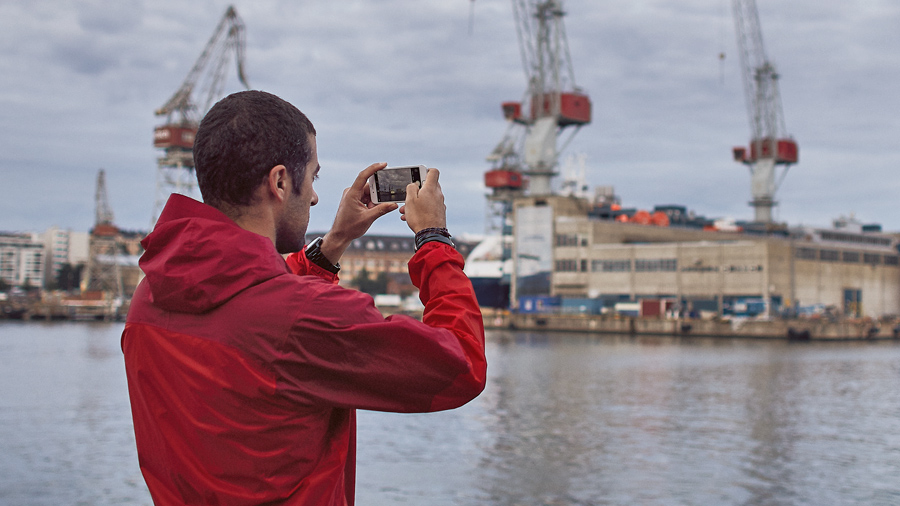 A person taking pictures in the harbour.