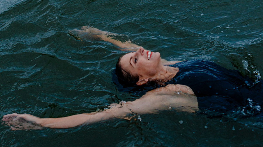 A person floating in water and smiling.