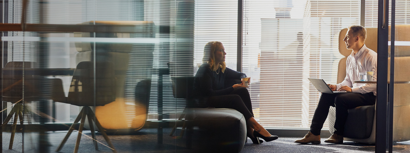 Two employees having a coffee at office.