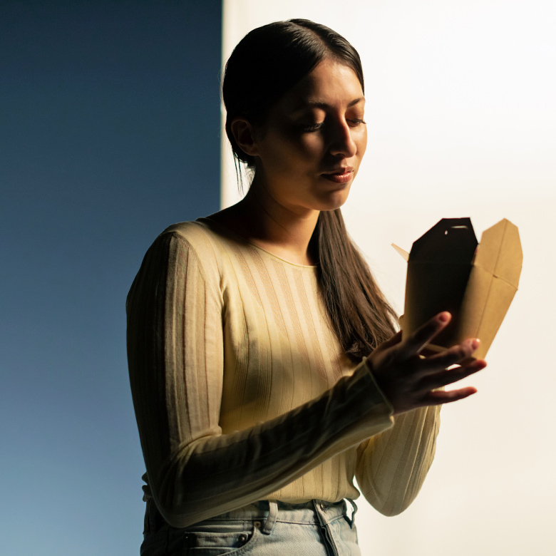 A person holding a food package.