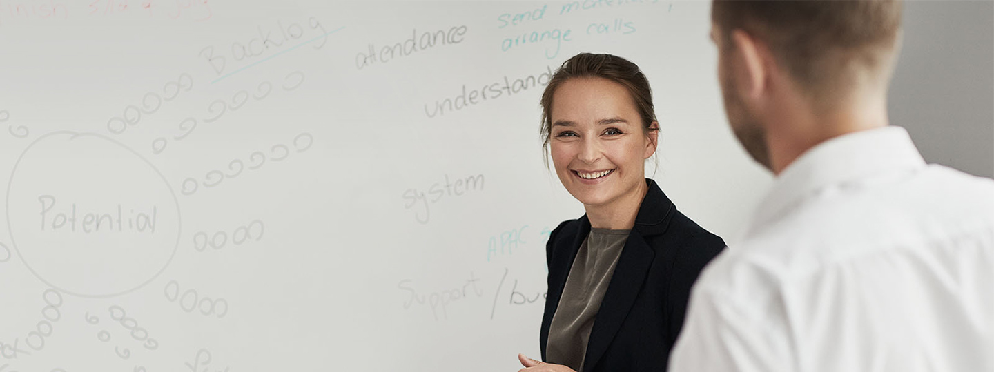 A person writing on whiteboard.