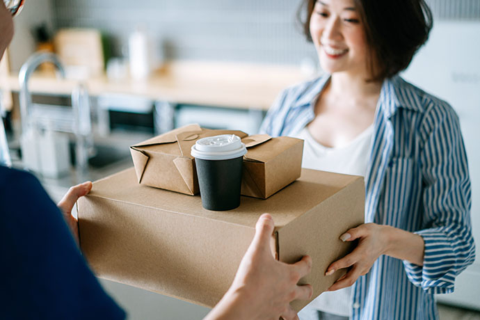 A person receiving cardboard packages