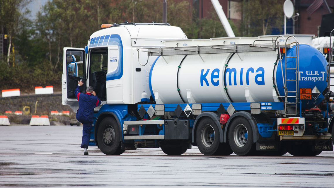 a truck driver getting in his vehicle at manufacturing site