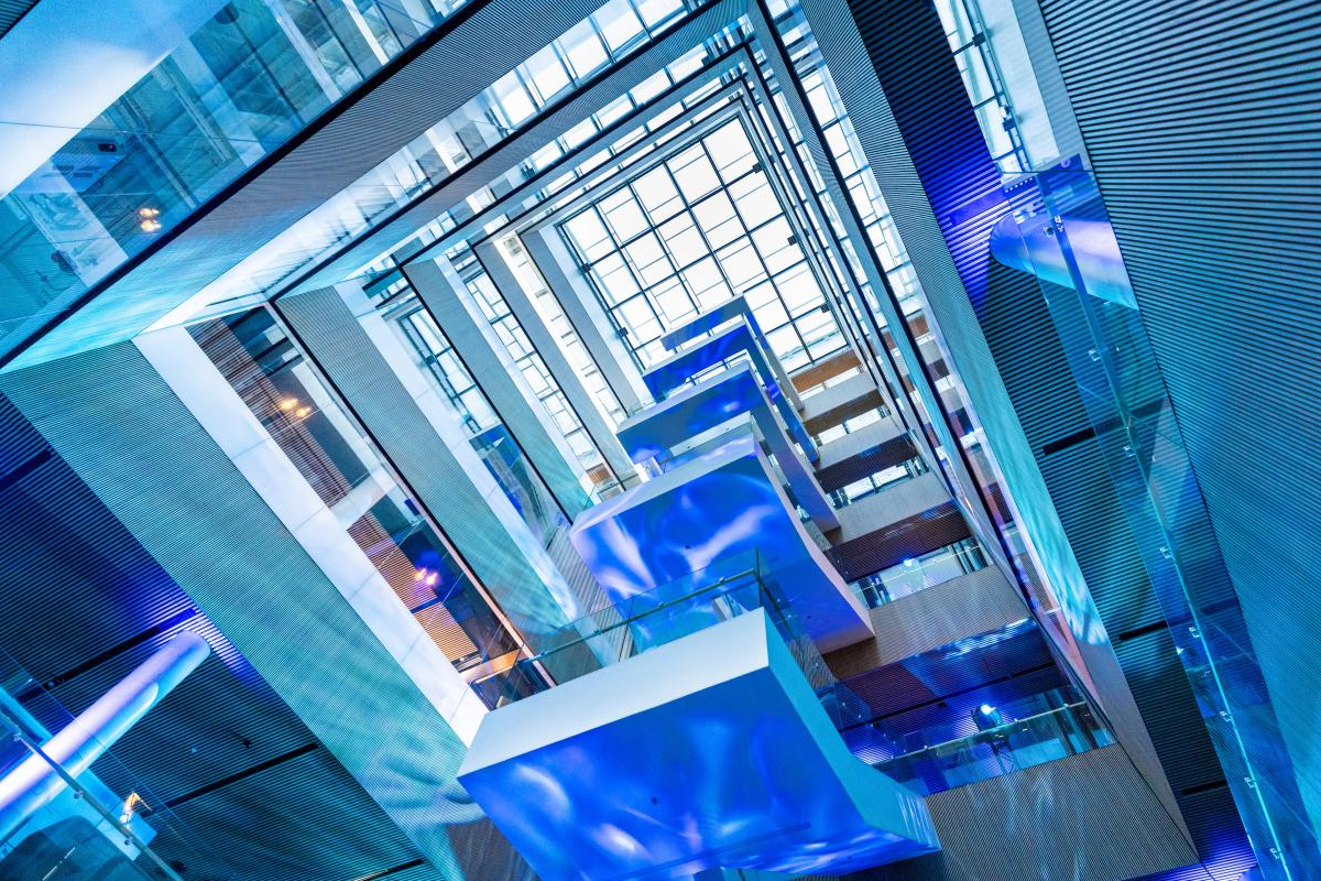 Modern interior of the Espoo office foyer with staircase and large windows.